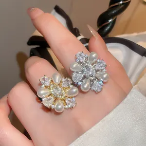 Close-up of elegant 14k gold plated flower ring with teardrop pearls and zircons