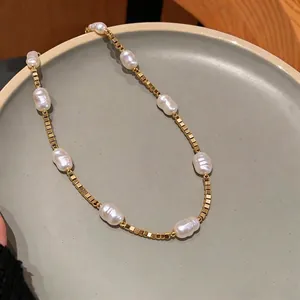 18K gold plated beaded necklace featuring elegant baroque pearls on a ceramic plate