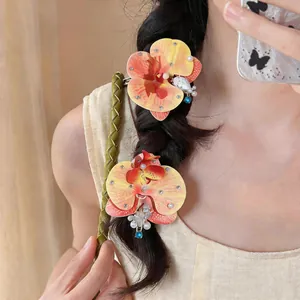 Gros plan détaillé d'une élégante pince à cheveux orchidée en tissu avec perles sur tresse