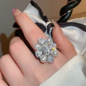 Macro view of vintage-style flower ring with pearls and brilliant cubic zirconia