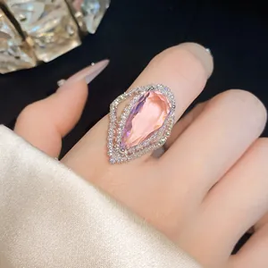 Detailed macro shot of a pear-shaped pink zircon ring with shimmering halo stones