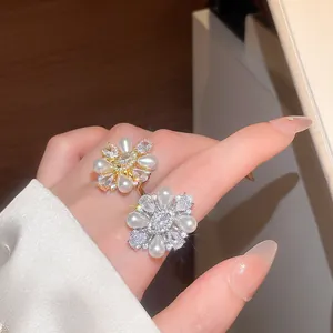 Detailed close-up of elegant flower rings with lustrous pearls and sparkling zirconia