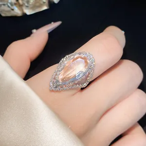 Close-up of elegant pear-shaped zircon adjustable ring on finger