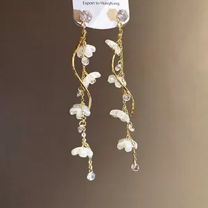 Elegant long gold tassel earrings with white shell flowers and cubic zirconia accents