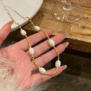 Detailed view of luxury 18k gold-plated beaded necklace featuring lustrous white pearls