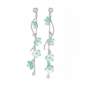 Elegant long tassel earrings with light blue flower charms, zircon stones, and silver needles.
