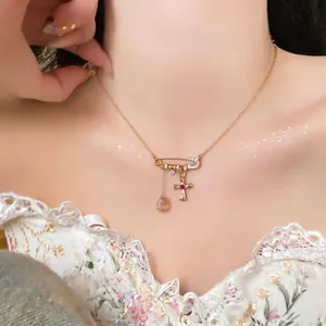 18k gold plated zircon necklace featuring a safety pin and crystal cross pendant
