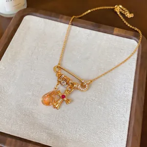 18k gold plated safety pin pendant necklace with cross and orange drop charms