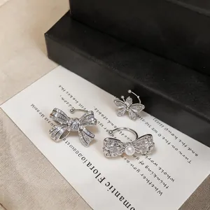 Set of silver-toned zircon ear cuffs featuring bow and butterfly designs