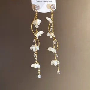 Elegant long tassel earrings with zircon stones and delicate white flower details