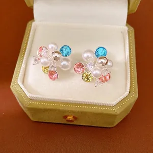 Colorful floral cluster stud earrings with pearls and crystals in a velvet box