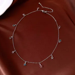 Detailed view of a silver-toned necklace featuring multiple colorful glass star charms.