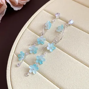 Elegant silver needle drop earrings with light blue zircon flowers and long tassels.