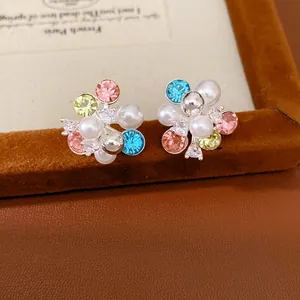 Detailed view of colorful flower cluster stud earrings featuring pearls and zircons.