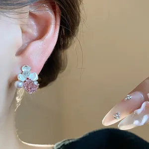 Detailed close-up of elegant flower stud earrings with pink rose zircon and dainty pearl