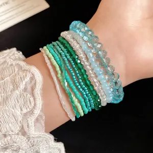 Bohemian 10-piece acrylic crystal and seed bead bracelet set in ocean blue and green tones