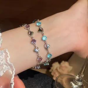 Close-up of elegant heart-shaped bracelets with sparkling pink and blue crystal stones