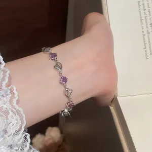 Detailed shot of elegant heart-shaped silver bracelet with sparkling purple crystals
