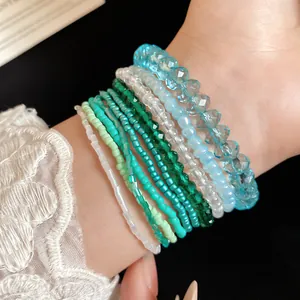 Close-up of 10-piece Bohemian style beaded bracelet set in shades of blue and green
