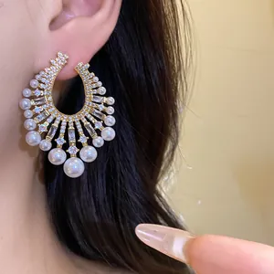 Detailed macro view of vintage French luxury hoop earrings adorned with pearls and zircons