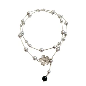 Layered grey pearl and silver tube necklace with a sparkling rhinestone flower pendant