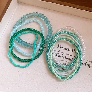 Close-up detail of 10-piece bohemian green and blue crystal beaded bracelet set
