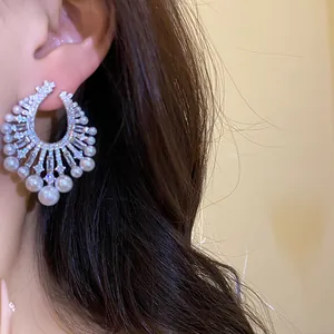 Detailed close-up view of vintage French style earrings with zirconia and pearls on ear