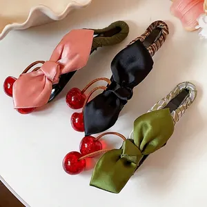 Set of three satin bow hair clips with red resin cherries in pink, black, and green.