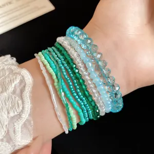 Close-up detail of 10-piece Bohemian style beaded bracelet set in blue and green