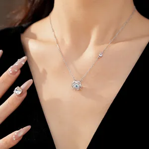 Close-up detail of elegant silver rotating flower necklace with blue zircon center
