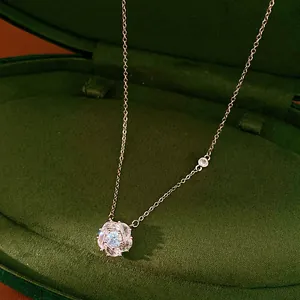Macro detail of the sparkling zircon-inlaid floral pendant and delicate chain.