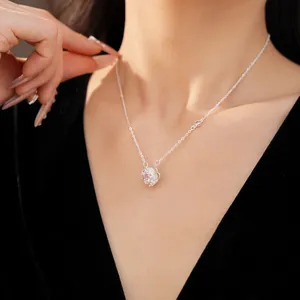Detailed macro view of an elegant rotating flower pendant necklace with pink zircon