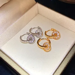 Elegant pavé crystal interlocking double hoop earrings in gold and silver finish