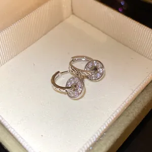Detailed view of elegant silver double-ring hoop earrings with pave clear stones