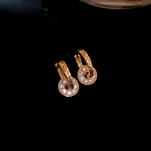 Detail macro view of gold-tone double hoop earrings with pave cubic zirconia circles