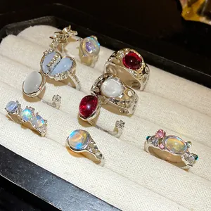 Close-up of a 9-piece set of assorted resin and rhinestone open rings in a display tray