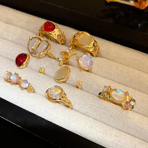 Detail of 9-piece gold ring set featuring varied resin stones and celestial motifs