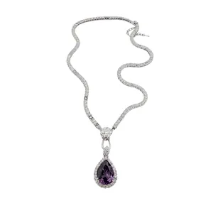 Vintage silver necklace with purple teardrop gemstone and flower pendant