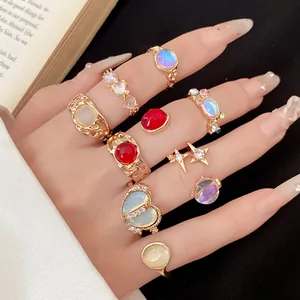 Close-up of 9-piece gold adjustable ring set featuring colorful resin stones and rhinestones