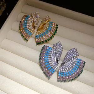 Close-up of vintage geometric earrings with colorful stone inlays in jewelry tray