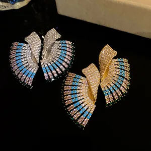 Close-up detail of vintage fan-shaped earrings with colorful sparkling crystals and stones