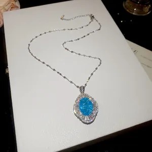 Close-up of vintage blue oval stone pendant necklace with sparkling zircon details