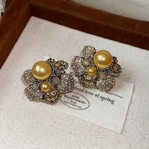 Exquisite vintage floral stud earrings with sparkling rhinestones and champagne pearls