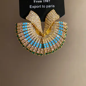 Vintage court style earring with crystals, turquoise, and emerald stones.