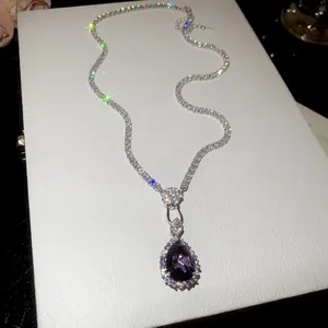 Macro view of vintage purple teardrop pendant necklace with sparkling tennis chain details