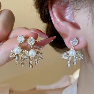 Elegant 18k gold plated bow-knot earrings with white pearls and sparkling zircons