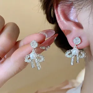 18K gold plated bow earrings with sparkling cubic zirconia and elegant white pearls