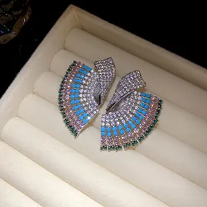 Detailed shot of vintage geometric earrings with colorful pavé stones in velvet box