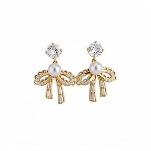 Elegant 18k gold plated bowknot stud earrings with sparkling zircons and a central pearl