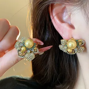 Close-up detail of vintage style flower earrings featuring pearls and sparkling rhinestones